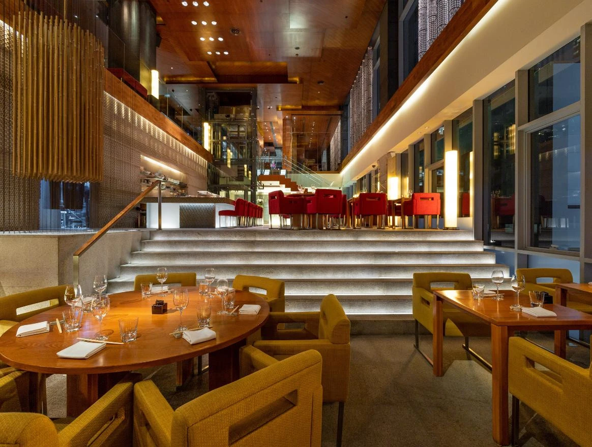 Dining tables and a raised dining area inside Zuma Dubai.